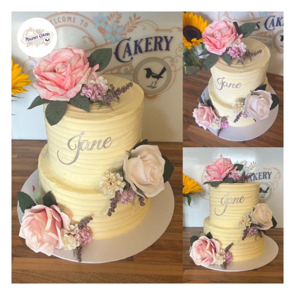 Two tier full buttercream finish birthday cake finished with faux flowers and personalised card topper Magpies Cakery, cake maker & decorator, Lincoln & Newark