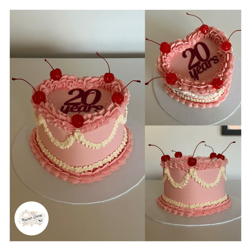 Vintage style heart pink buttercream finish cake with cocktail cherries. Magpies Cakery, cake maker & decorator, Lincoln & Newark UK